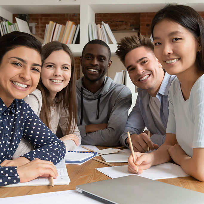 A group of smiling multiethnic students and teachers